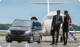 Yellow Star Express Taxi van beside travelers and an aircraft